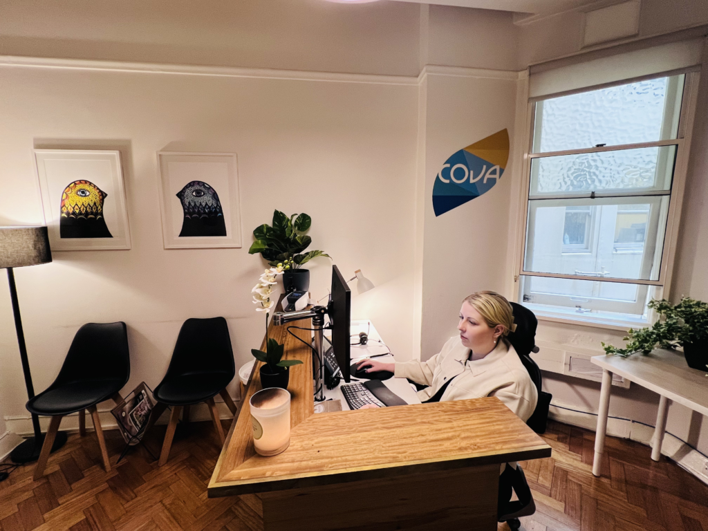 Reception area at Cova Psychology's Melbourne clinic with a friendly receptionist, welcoming clients for depression and mental health care.