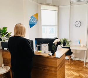 Person at Cova Psychology's Melbourne reception desk, featured in a blog post about numbness by a clinical psychologist in Melbourne.